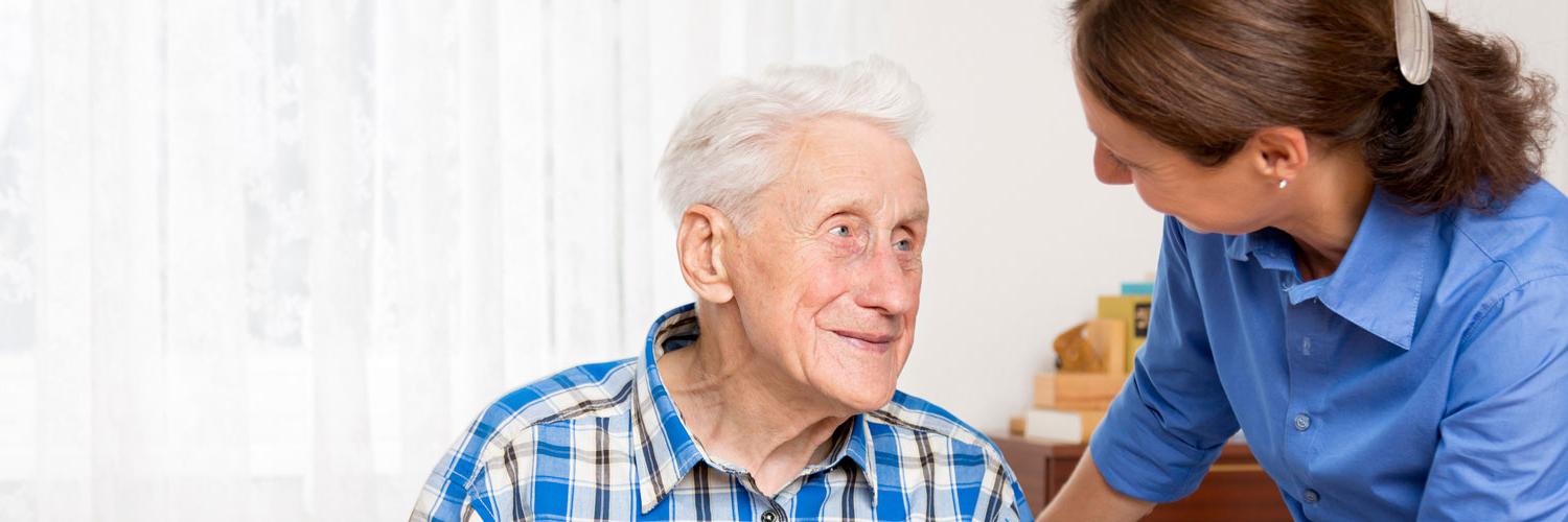 Caregiver talking with elderly man